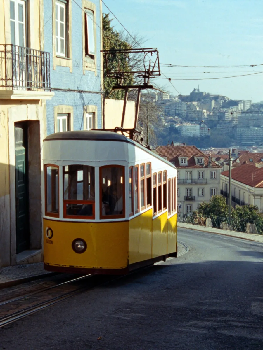 A yellow tram on a Lisbon street
